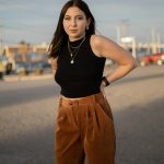 pexels photo 16346899 16346899 Woman in black crop top and brown pants posing outdoors at sunset.